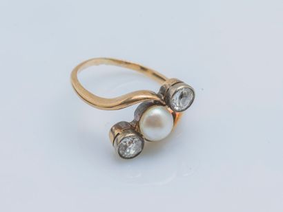  An 18k yellow gold ring (750 ‰) set with a button half-pearl shouldered by two old-cut...