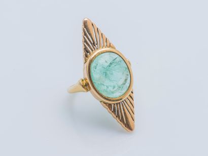  An 18k yellow gold (750 ‰) marquise ring set with a green quartz cabochon framed...