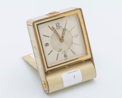 JAEGER, vers 1950 Square Memovox travel alarm clock in gilt metal and cream lacquer....