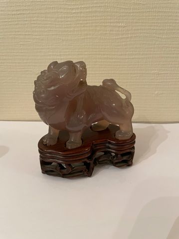 null Agate subject representing a Buddhist lion standing, head backwards.

China,...