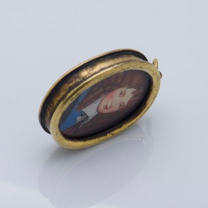 null Metal pendant holding a portrait of a young man in 17th century dress, the back...