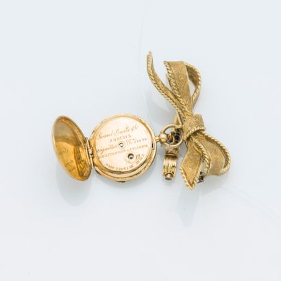 null Petite montre de col et sa broche nœud en or jaune 18 carats (750 ‰), le nœud...