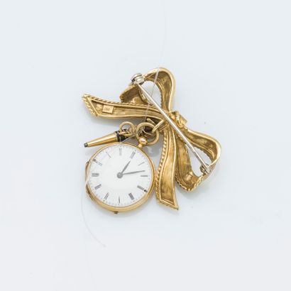 null Petite montre de col et sa broche nœud en or jaune 18 carats (750 ‰), le nœud...