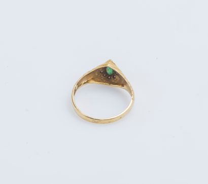 null 18K (750 ‰) yellow gold ring adorned with a drop emerald, within a surround...