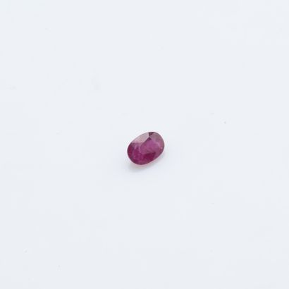 An oval ruby on paper weighing about 1.