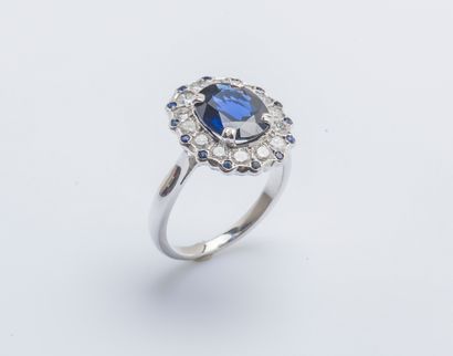 null 
Flower ring in 18K white gold (750 thousandths) set with an oval sapphire of...