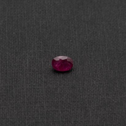 null An oval ruby on paper weighing about 1.