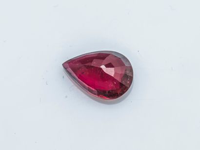 null Raspberry pink pear tourmaline on paper, weighing approximately 2.6 carats.