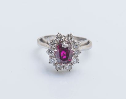 null 
Flower ring in white gold 18 carats (750 thousandths) set with a purplish red...