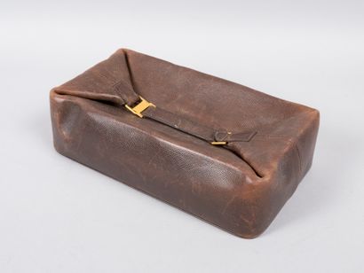 HERMES Paris HERMES Paris, 

Brown grained leather Poche Cloche toiletry bag, golden...