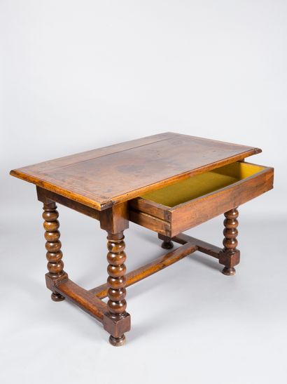 null Natural wood table opening with a drawer in the waist, resting on turned wooden...