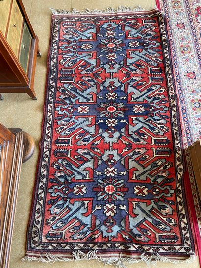 null Oriental carpet with geometric patterns in blue and red tones 

200 x 104 c...