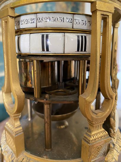 null Marble and gilt bronze clock with a revolving dial, the enamelled dial with...