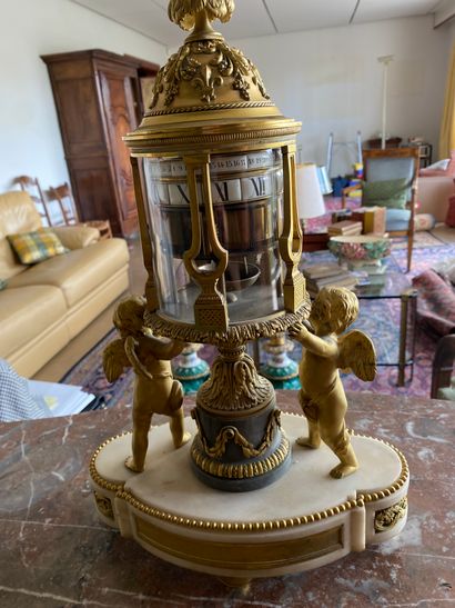 null Marble and gilt bronze clock with a revolving dial, the enamelled dial with...