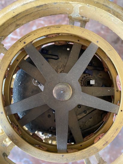 null Marble and gilt bronze clock with a revolving dial, the enamelled dial with...