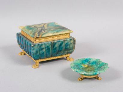 null Lot including a jewel box in hard stone with gadrooned decoration resting on...