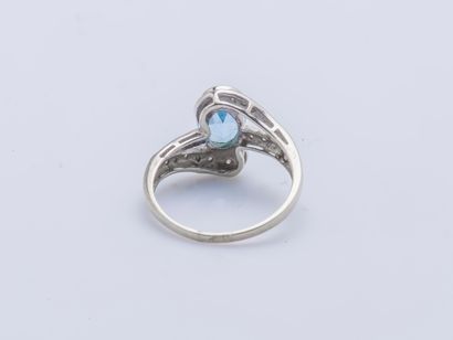 null Ring in 18K white gold (750 thousandths) set with an oval topaz surrounded by...