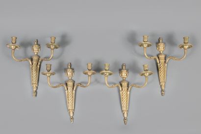 Suite of four two-light ormolu sconces decorated...