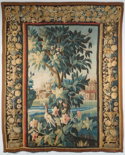 Tapestry of greenery with a heron in front...