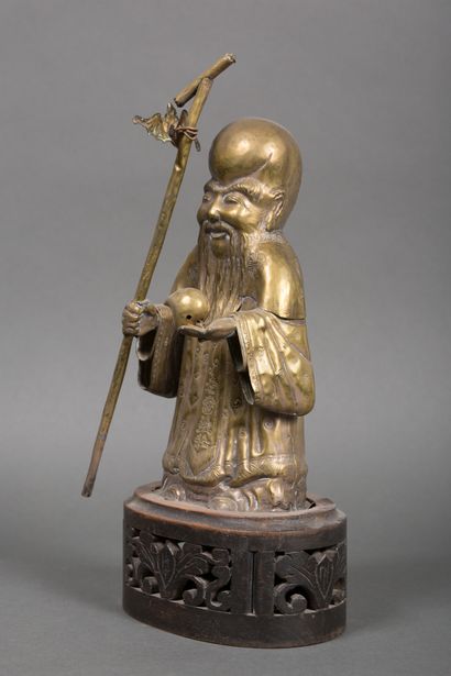 null Chine 
Statuette en laiton doré repoussé figurant un sage tenant la pêche de...