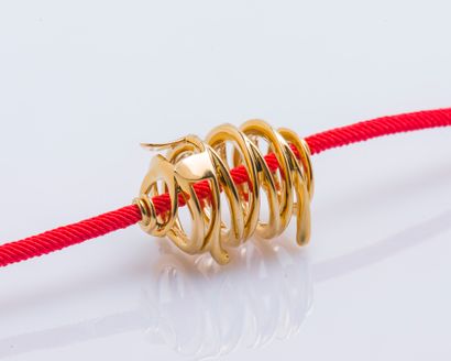 TTF Bracelet formed by a pendant drawing a pig in 18K yellow gold (750 ‰) wire twisted...