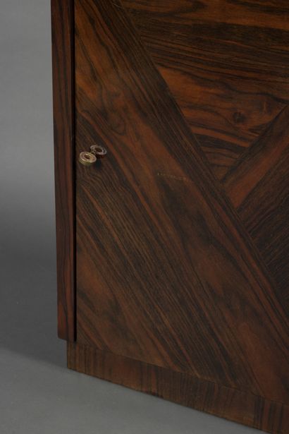 null Rosewood veneered bar cabinet opening with a flap and a leaf, revealing glass...