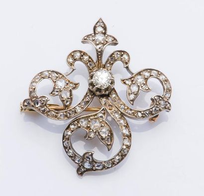 null Broche fleuron en or jaune 18 carats (750 millièmes) et en argent (925 millièmes)...