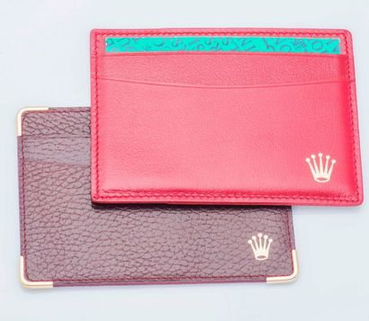 ROLEX Lot de deux porte-cartes en cuir, rouge et bordeau. 

