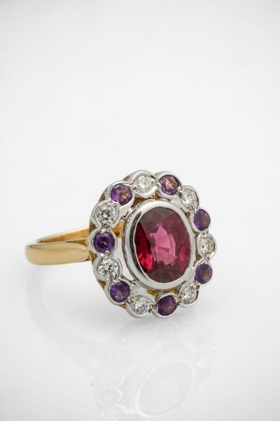 Two gold oval ring set with an oval rhodolite...