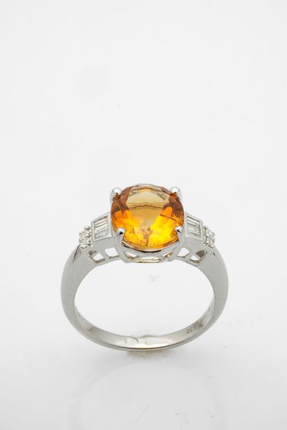White gold ring set with an oval citrine...