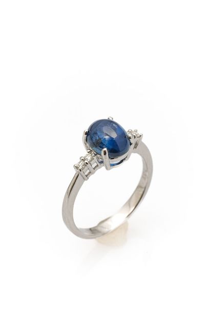 White gold ring set with a cabochon-cut sapphire...