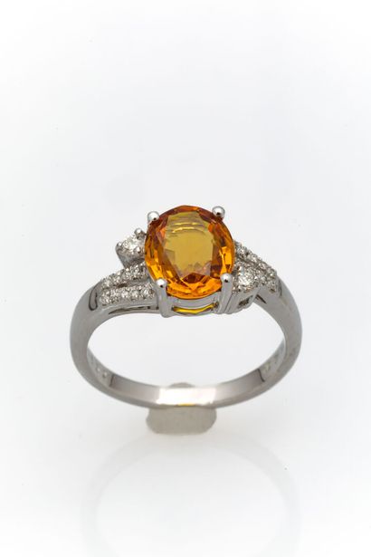 White gold ring adorned with a treated yellow...