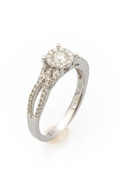 White gold ring set with a diamond weighing...