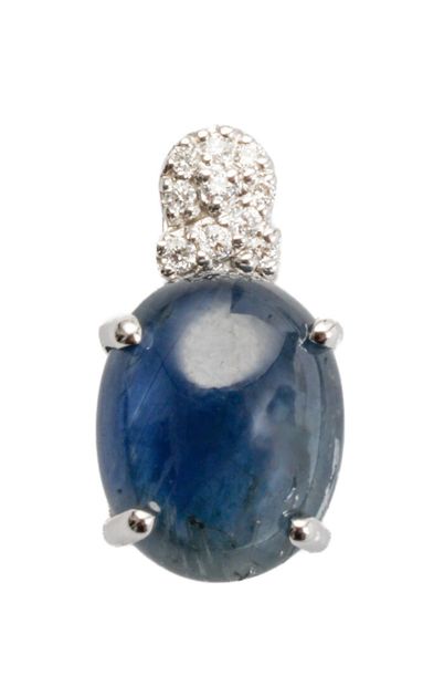 null 18K white gold pendant adorned with a cabochon-cut sapphire (slight chips) weighing...