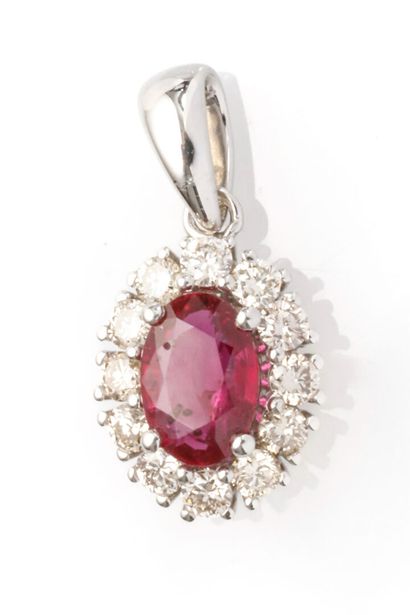 null 18K white gold daisy pendant adorned with a ruby, approx. 0.50 carat, set in...