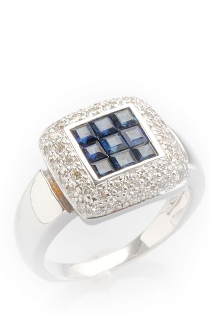 18K white gold ring set with calibrated sapphires...