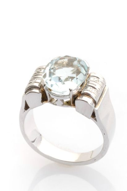 null 14K white gold Tank ring set with an oval-cut Aquamarine weighing approx. 3...