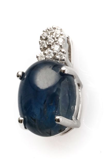 null 18K white gold pendant adorned with a cabochon-cut sapphire (slight chips) weighing...