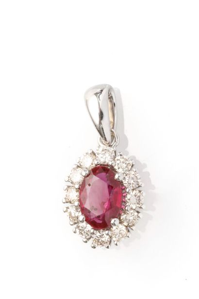 null 18K white gold daisy pendant adorned with a ruby, approx. 0.50 carat, set in...