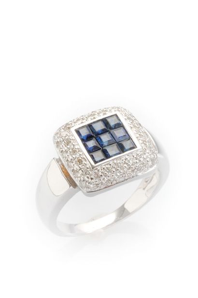 null 18K white gold ring set with calibrated sapphires in a double entourage of diamonds.
Weight:...