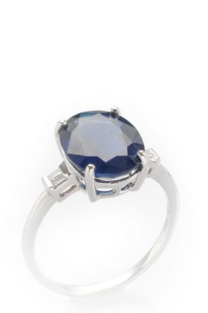 null 18K white gold ring set with an oval-cut sapphire weighing approximately 4 carats,...