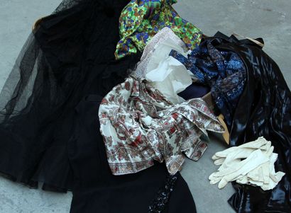 null Set of DRESSES and feminine clothes in a suitcase including a black tulle dress,...