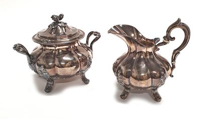  Covered SUCTION JUG and MILK POT in silver decorated with large ribs on four leafy...