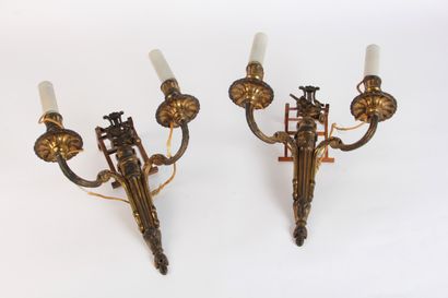 null A pair of two-light chased and gilt bronze APPLIQUES decorated with musical...