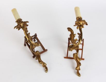 null A pair of two-light chased and gilt bronze APPLIQUES decorated with musical...