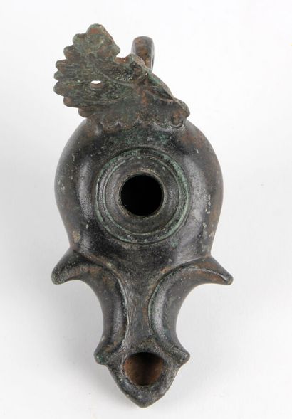 null OIL LAMP with a scrolled spout and a reflector in the shape of an acanthus leaf.
Bronze
Greco-Roman...