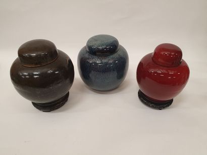 null Three covered ball VASES, one in black glazed stoneware, the second in oxblood...
