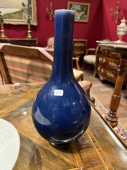 null A blue enameled porcelain globular vase with a long neck.

China, 19th century,...