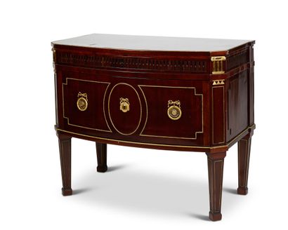 null A mahogany curved COMMODE opening with two drawers, the first narrow one carved...