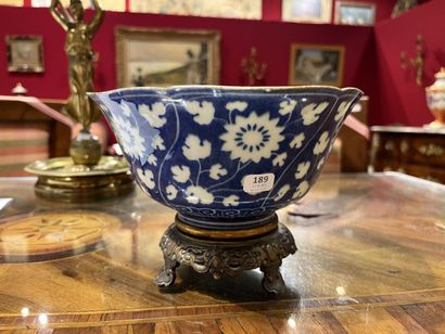 null Porcelain and white-blue enamel corolla cup on heel with flowers and foliage...